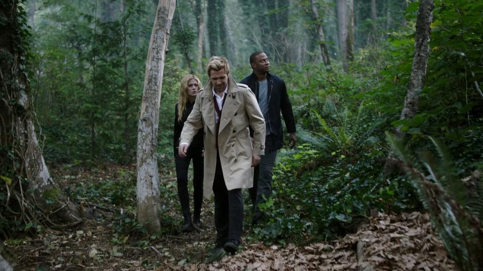 Mia, Constantine, and Diggle walk through the woods searching for Oliver's soul.