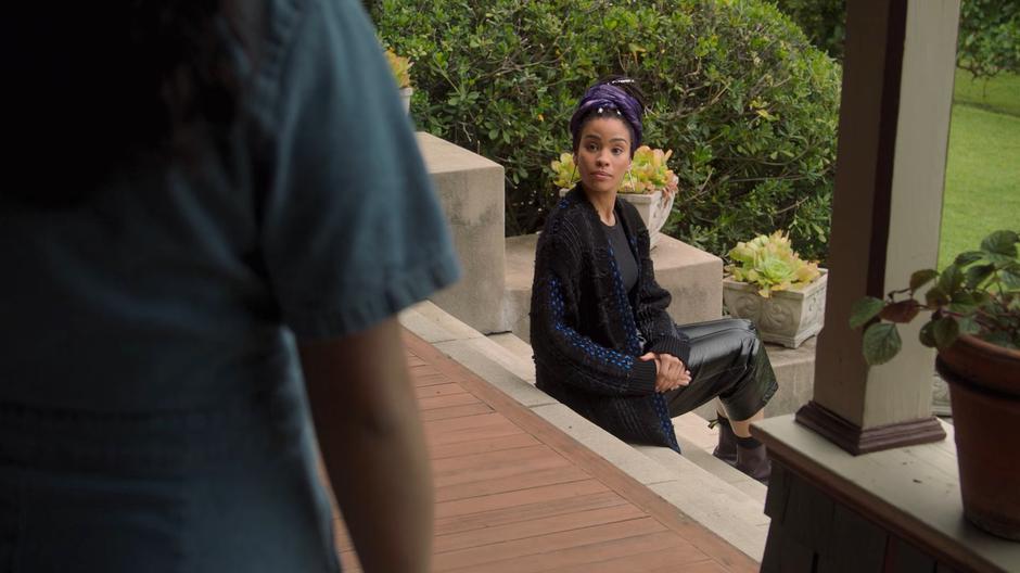 Xavin sits on the steps and motions for Molly to sit next to her.