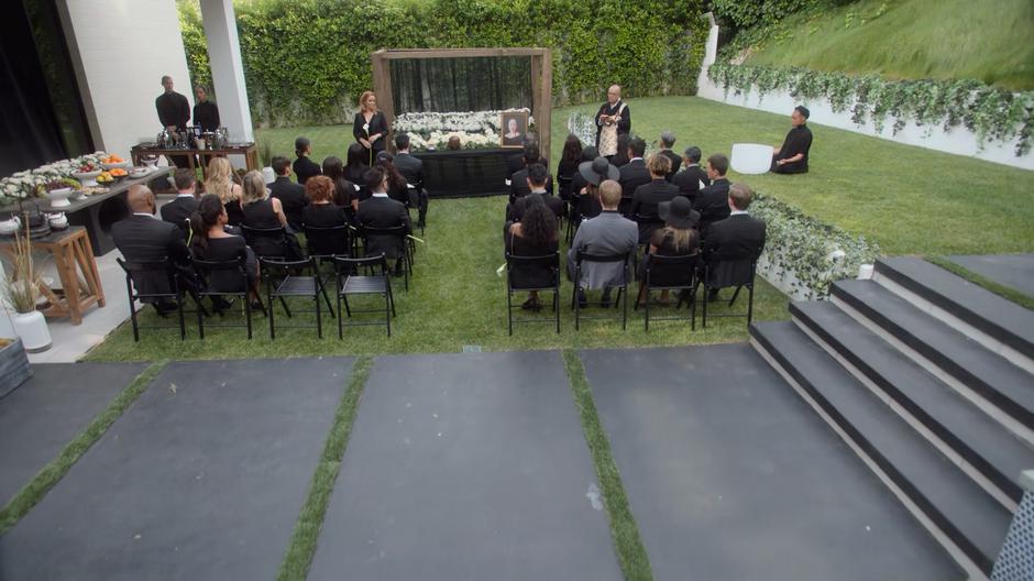 Leslie stands at the front while the rest of the families sit during Amy's memorial.