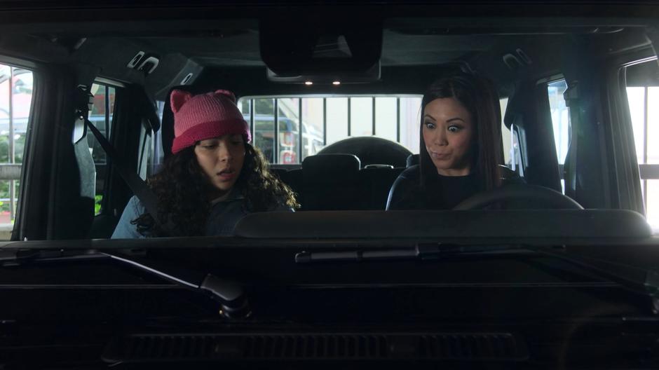 Molly tries to convince Xavin to let her drive while Xavin, in the guise of Tina, examines the car's controls.