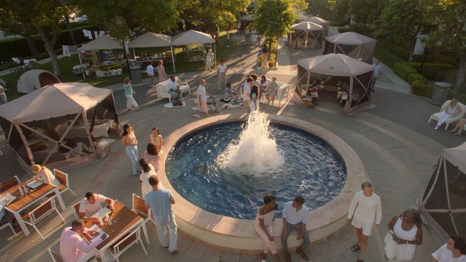 Members of the new church mingle around the fountain.