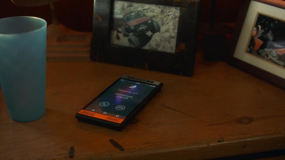 A Wiz Phone Corvus rings on the nightstand with an unknown caller.