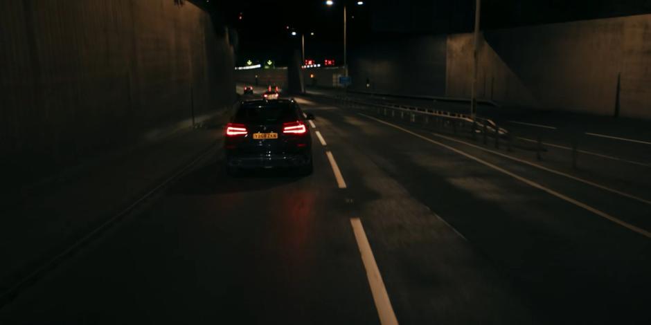 The government vehicle drives down the motorway into the tunnel.