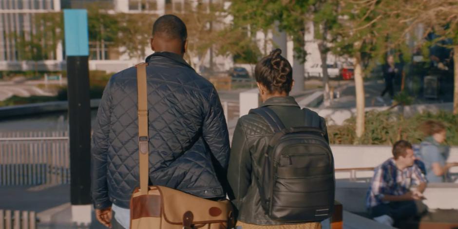 Ryan and Yaz walk across the plaza towards the offices.