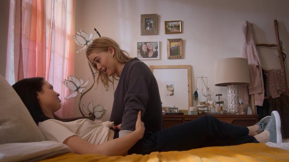 Karolina sits on the bed next to Julie and talks about her feelings.