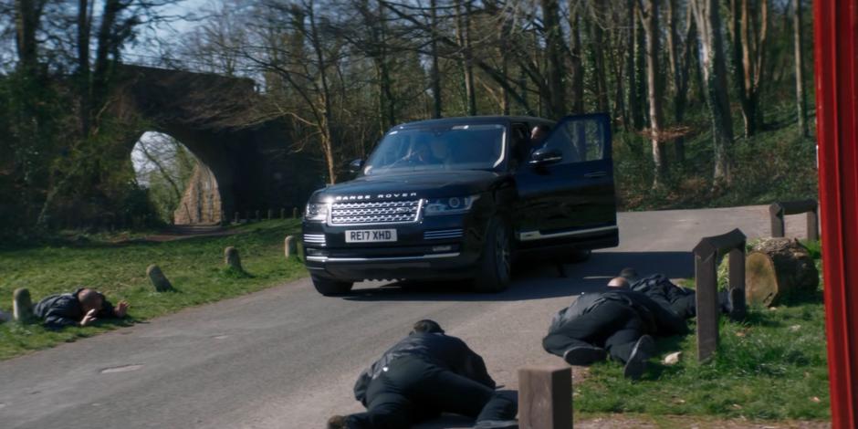 The goons lie on the ground as Ryan gets into their car with Yaz and Graham.