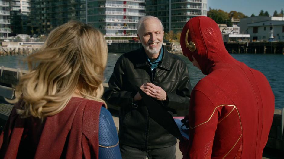 A man asks Kara and Barry for their autograph.