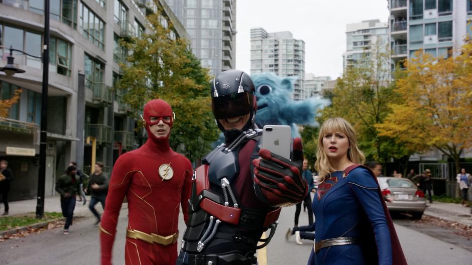 Barry and Kara turn from the rampaging Beebo to see Ray taking a selfie.