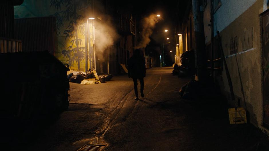 A hooded figure starts following Maggie from the dark alley.