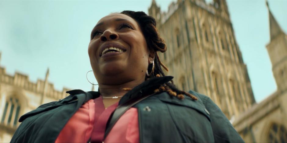 Ruth stands in front of the cathedral trying to drum of business for her city tour.