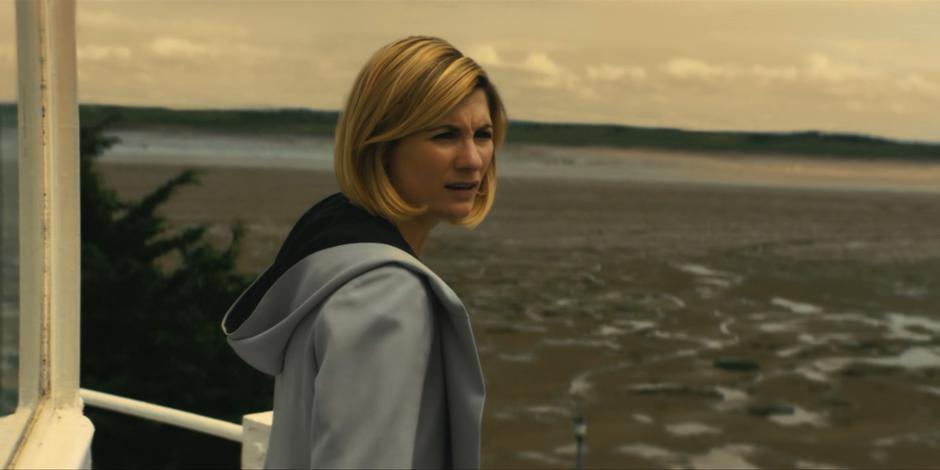 The Doctor spots the lone gravestone near the lighthouse.