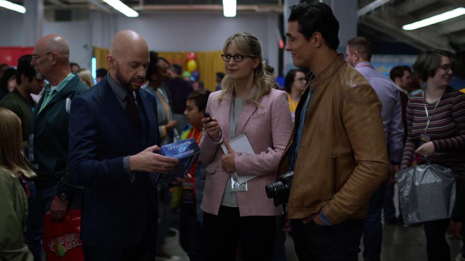Kara and William listen to Lex as he talks about his new action figure.
