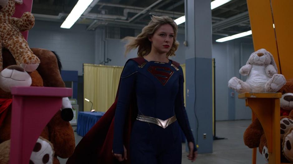 Kara emerges after changing into her Supergirl suit.