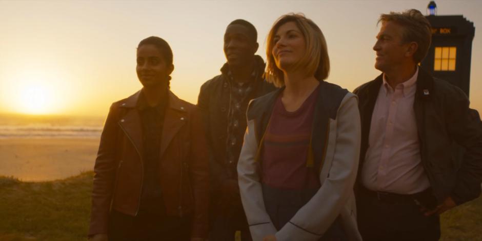 Yaz, Ryan, the Doctor, and Graham say goodbye to their new friends as the sun sets over the water.