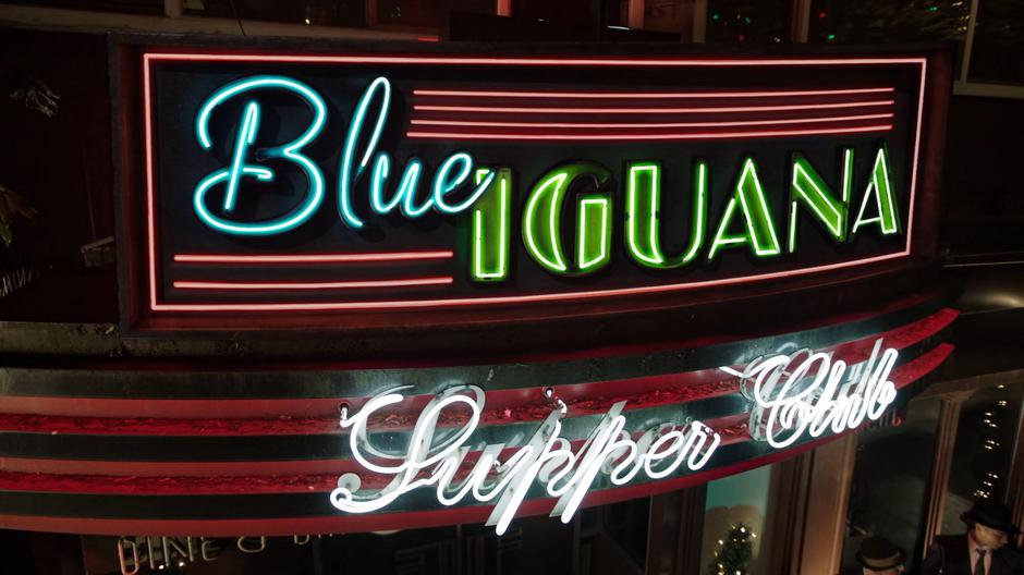 Establishing shot of the neon Blue Iguana Supper Club sign.