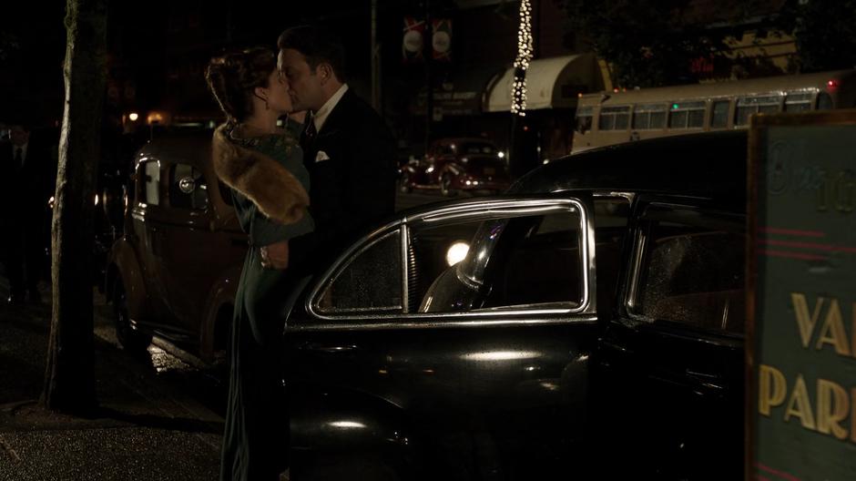 Bugsy kisses Jeanie Hill after getting out of his car outside the club.