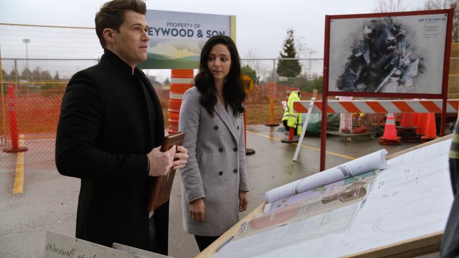 Nate and Zari look over plans for the unfinished Heyworld.
