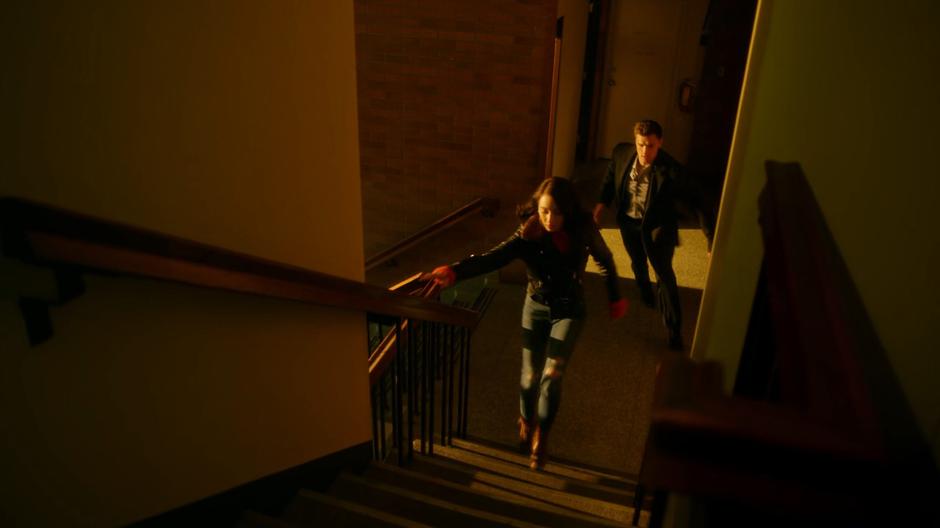 Sue and Ralph run out of John Loring's office towards the roof.
