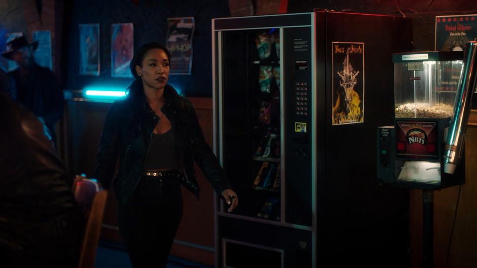 Iris walks through the bar while looking for someone she can get answers from.