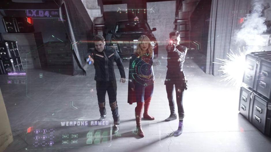 Winn, Kara, and Alex attack one of the drones.