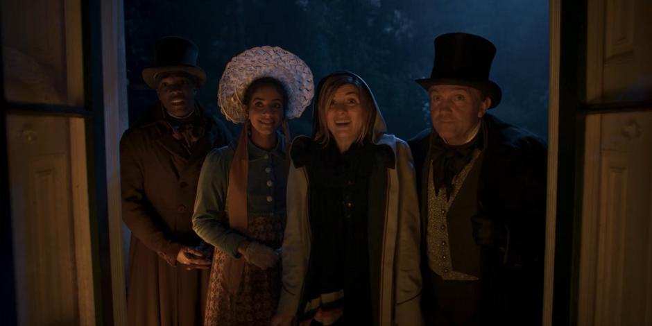 Ryan, Yaz, the Doctor, and Graham smile and ask to come inside out of the rain.