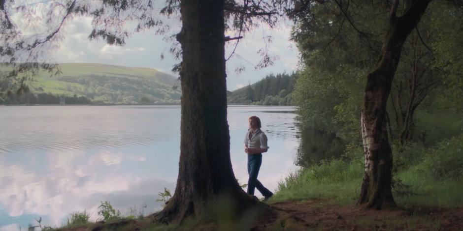 Percy walks along the lake on a sunny day.