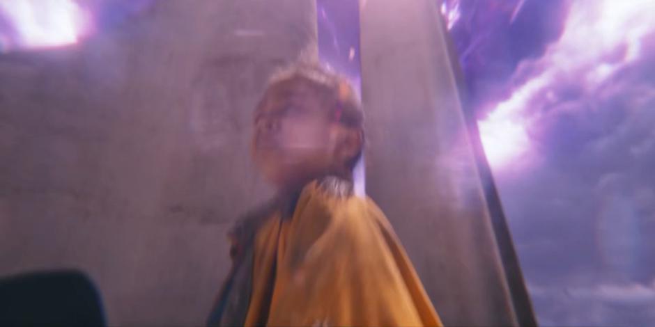 The Timeless Child appears in the Doctor's vision under a purple sky.