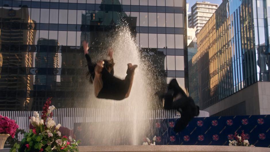 Zari and Ava leap into the fountain.