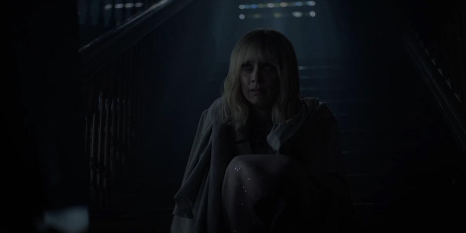 Alice tells Jacob what happened to her mother while she sits on the stairs with a blanket draped around her shoulders.