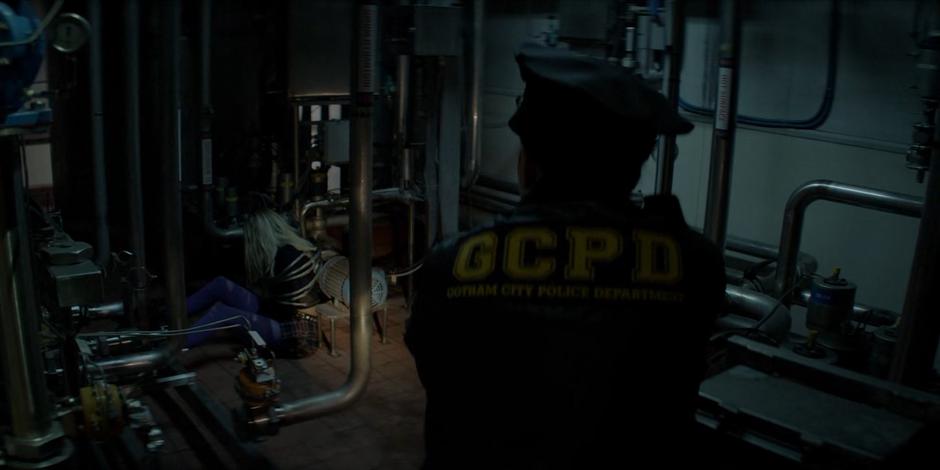A GCPD officer finds Duela Dent tied up in a back room.