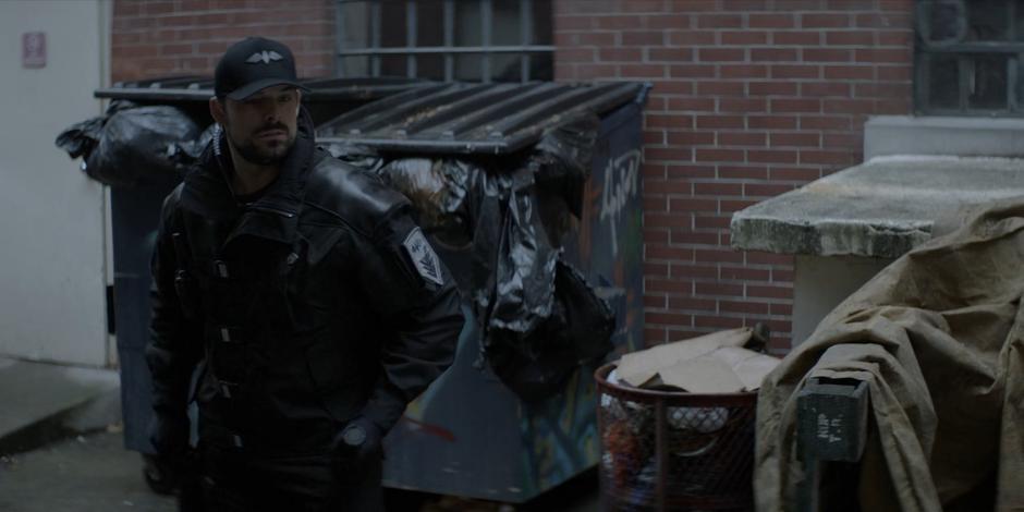 A Crows Security guard patrols the alley behind the hospital.