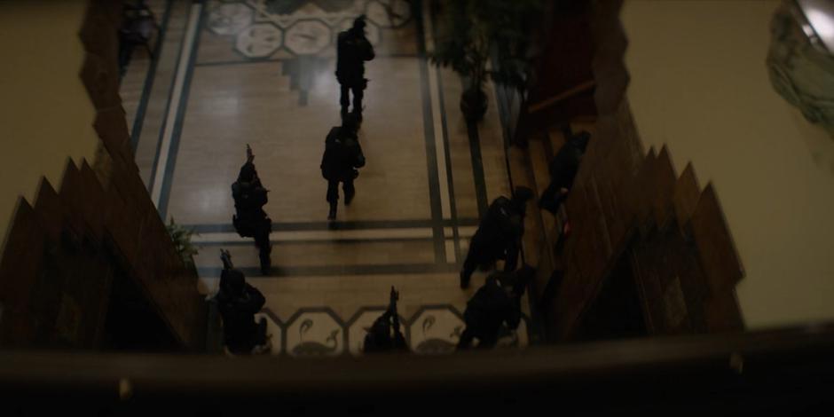 The Crows Security team storms through the lobby with weapons ready.