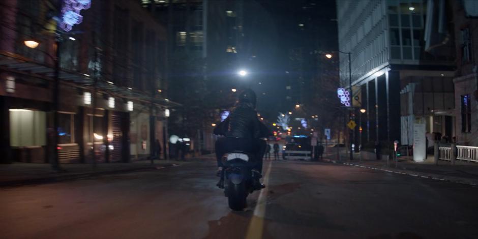 Luke rides towards a Crows Security checkpoint on the Batcycle while carrying Beth.