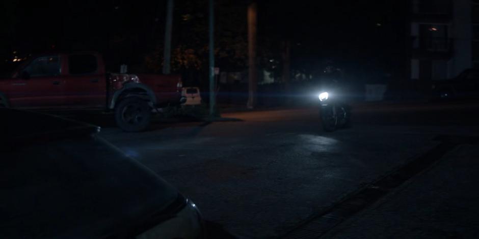 Luke pulls into the parking lot with Beth on the Batcycle.