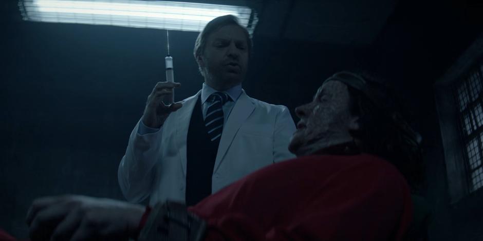 Dr. Butler stands over Mouse with a giant syringe.