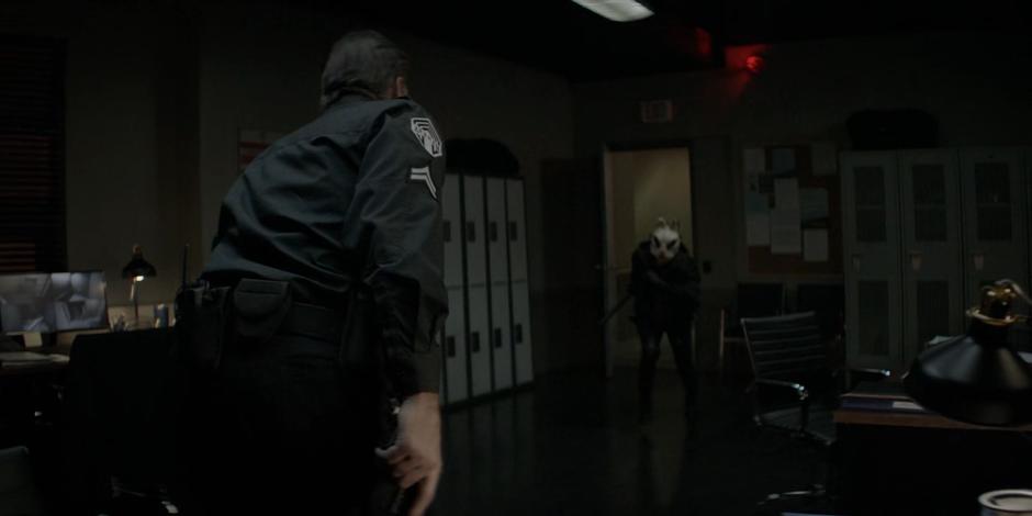 The head of security reaches for his gun as Kate runs towards him in a mask.