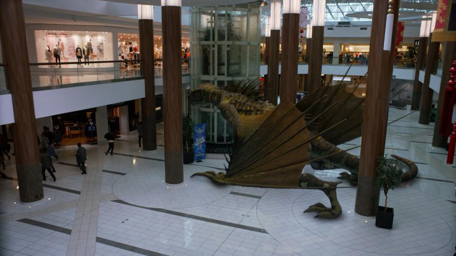 People flee as the dragon lands in the middle of the mall.
