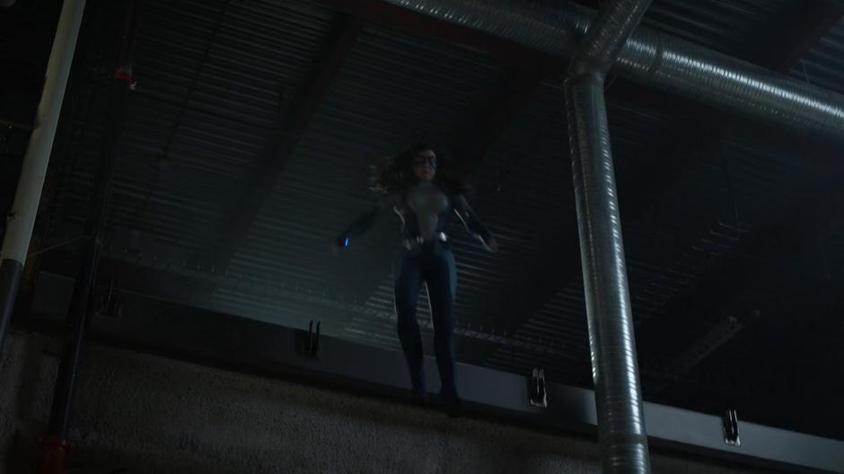 Nia jumps down from above to confront Alex.