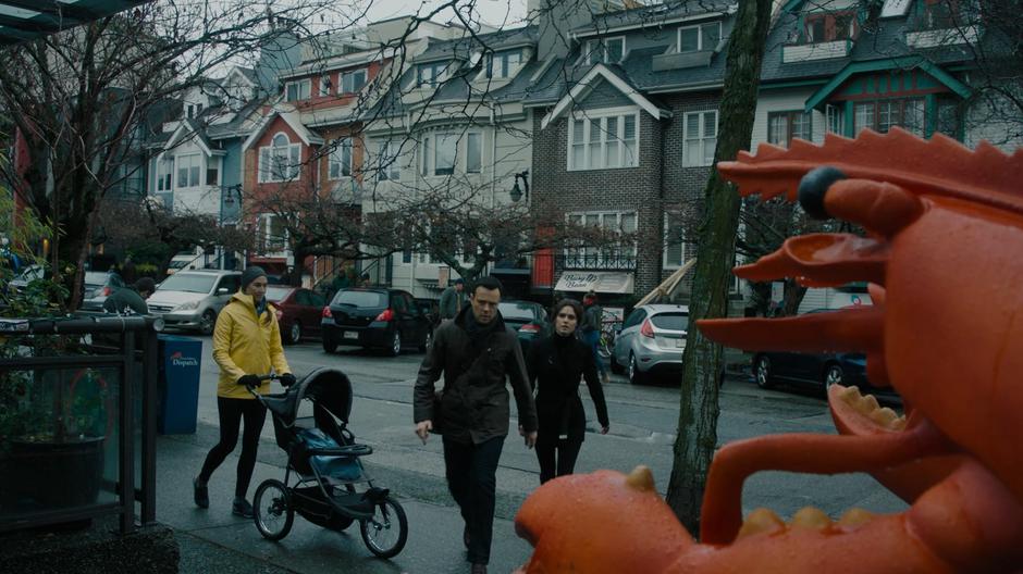 Abigael follows Harry as he rushes across the street.