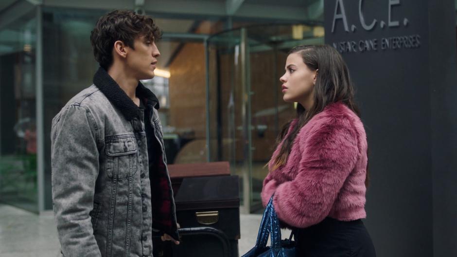 Maggie meets Parker outside the building as he is pulling a cart of his stuff towards his car.