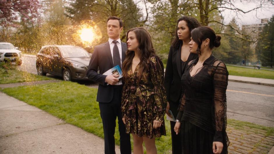 Chloe appears as a magical ball of light in front of Harry, Maggie, Macy, and Mel.