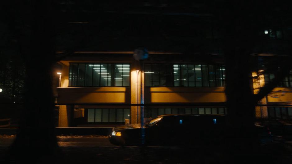 The limo carrying Harry and Nadia drives away from the facility.