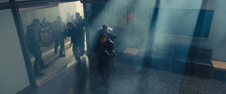 A gang of goons rushes into the station with submachine guns.