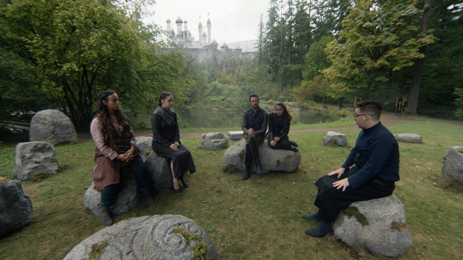 Julia, Fen, Eliot, and Margo sit in a circle with Josh who is telling them about a way he can find the tree.