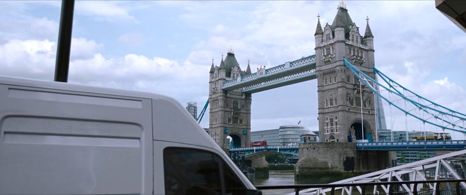 The control van sits in the foreground while the tour bus drives over the bridge in the background.