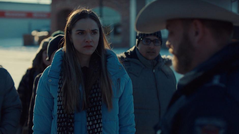 Chrissy stares daggers at Sheriff Clayborn as he stops her from killing Wynonna.