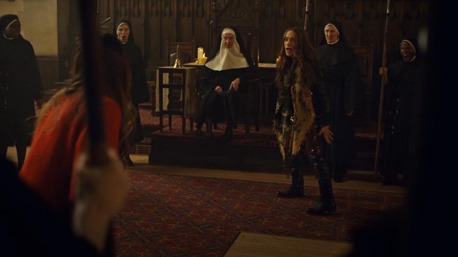 Wynonna tries to convince Rosita to not fight while then nuns surrounding them are cheering them on.