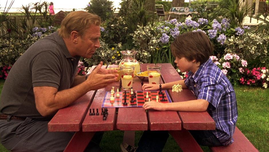 Henry tries to instil a lesson about paying attention to young Shawn as they play chess.