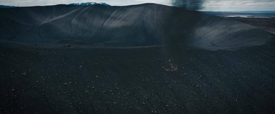 Fire burns on the edge of the crater where Michael crash landed.