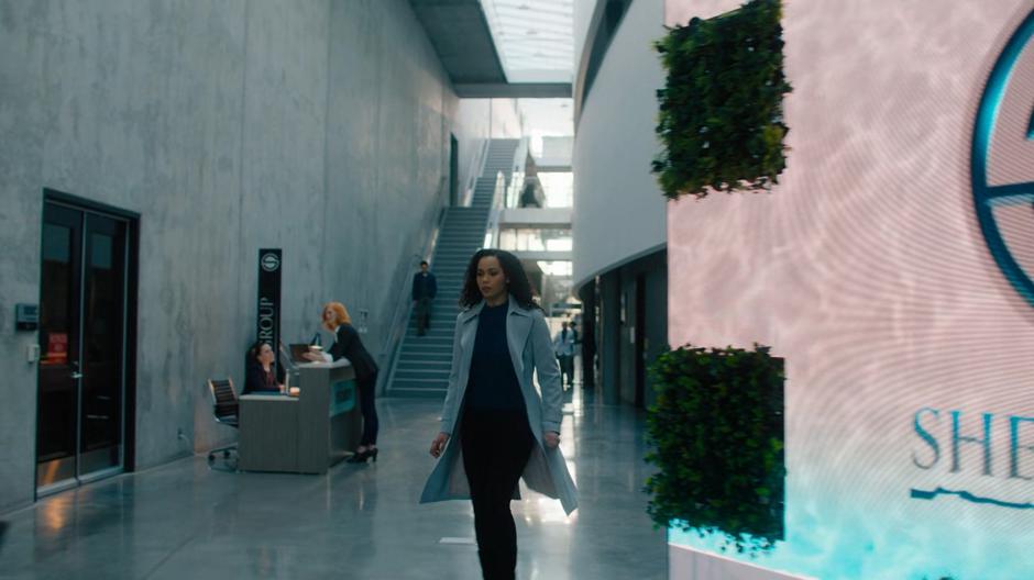Macy walks through the lobby of the company.